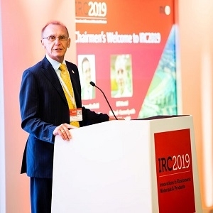 man in suit standing at a podium