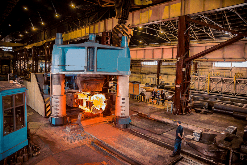 A factory with some workers and a molten metal
