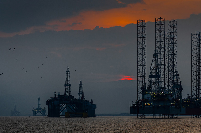 Sunset over the Cromarty Firth with retired oil rigs