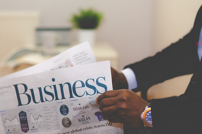 Man reading the business section of a newspaper