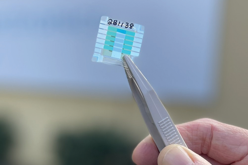Quantum battery prototype being held between tweezers