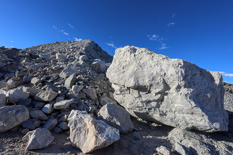 Stock image of lithium ore rocks against a blue sky