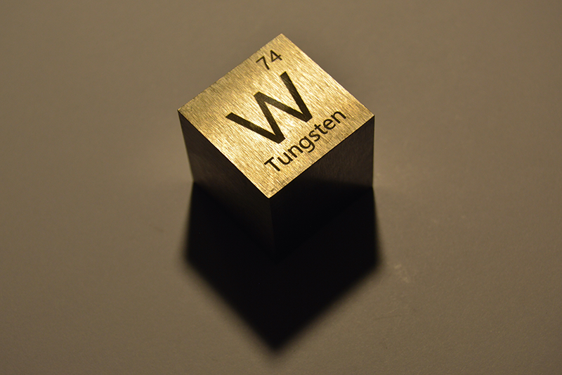 A block of tungsten with the element info carved into it