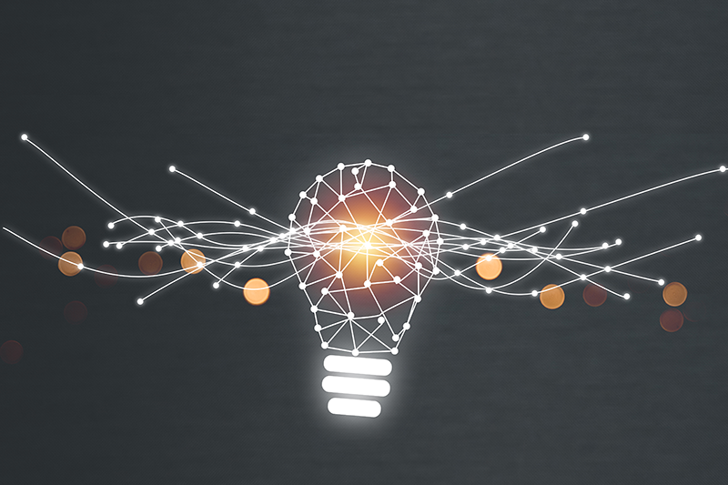 Stock image of filament bulb with drawn lines emanating outwards from the light