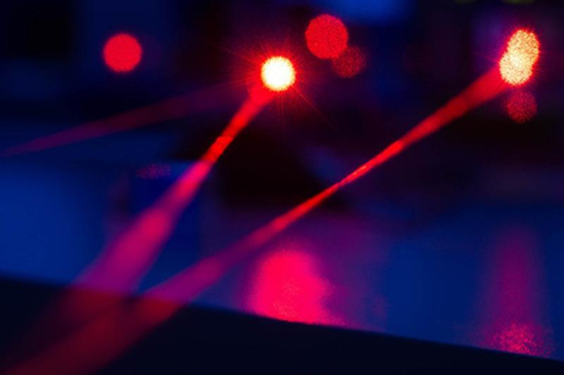 Very blurry image of red lasers on a dark background