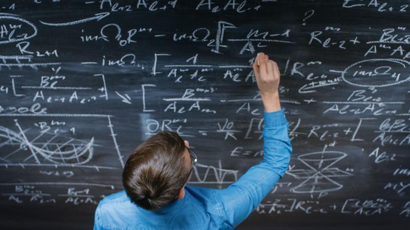 teacher at chalk board