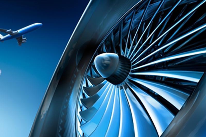 A jet engine turbine and a plane in the distance