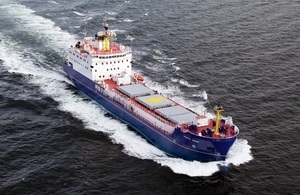 An areial view of the Pacific Grebe, a large blue ship, at sea