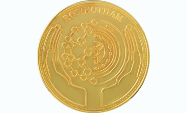 circular gold medal featuring two cupped hands and automotive related features, Rowbotham medial text is at the top edge