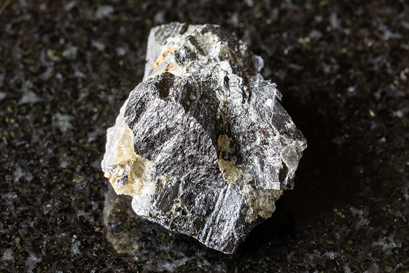 A sample of wolframite ore against a black background