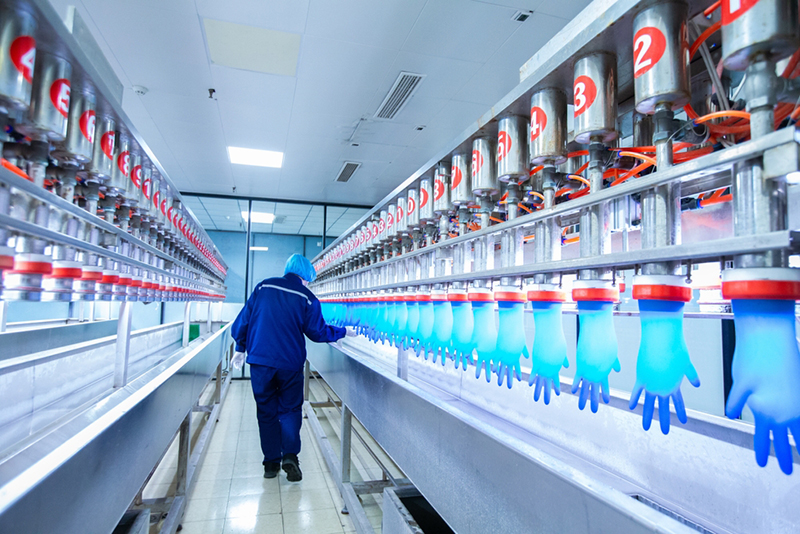 Rubber glove testing line with worker