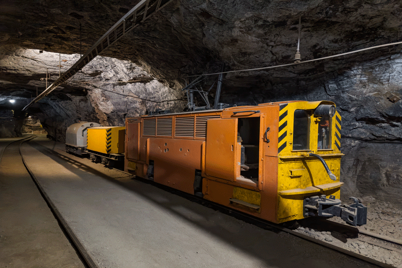 A train underground in a lit cave