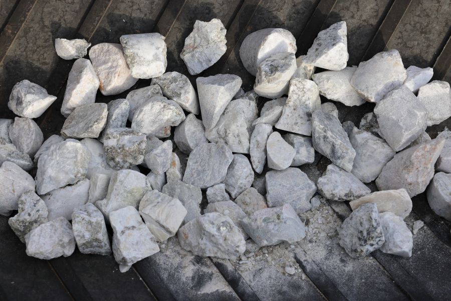 Spodumene hard rock ore on conveyor belt pictured. Processed into spodumene concentrate 6 or SC6, for subsequent production of lithium-ion batteries.