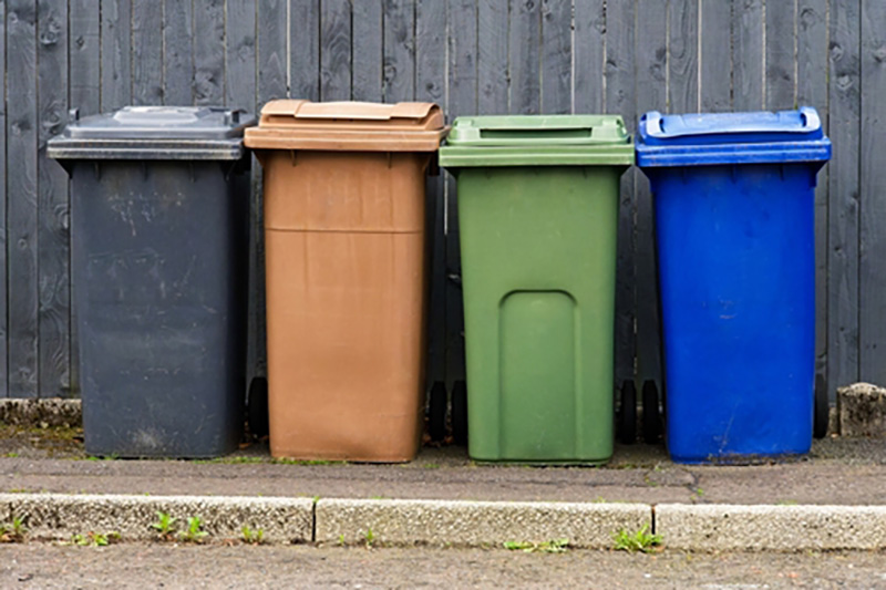 UK wheelie bins of different colours to denominate different types of waste collection