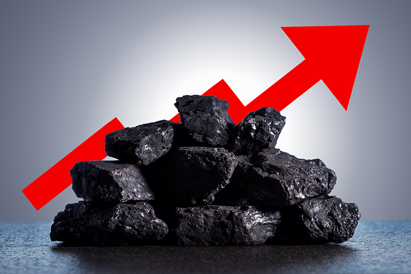 Pile of coal in front of a red 'increasing' arrow
