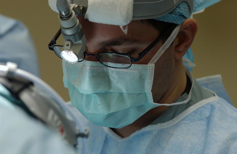 Surgeon wearing a mask during surgery