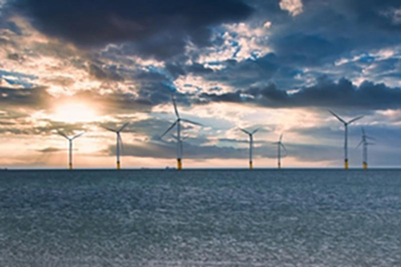 Offshore wind turbines with lots of clouds at sunset