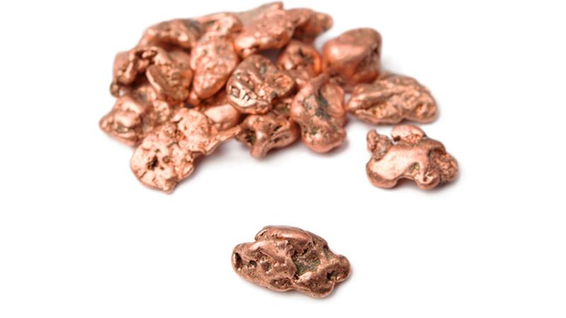 copper coloured nuggets on a white background