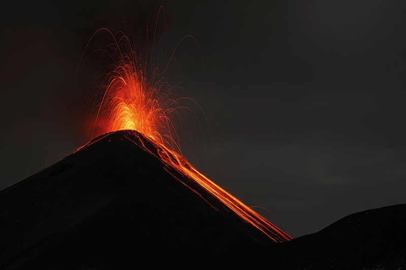 A volcano erupting against a dark sky