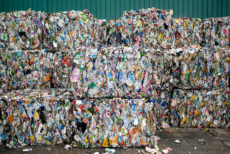 Multicoloured bales of plastic containers packed up for recycling