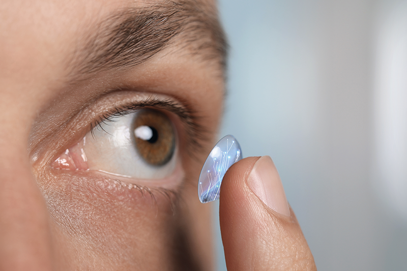 Stock image of someone about to put a 'smart' contact lens in their eye