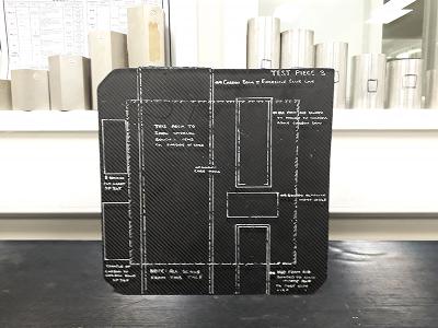 The front side of a composite test panel showing the various complex additions to the rear of the panel which the inspector will train to locate from the front