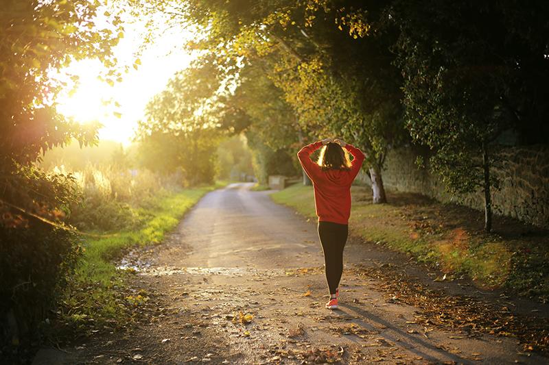 person walking in the sun