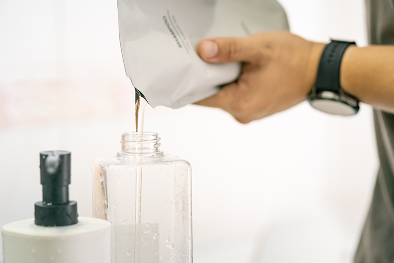 Stock image of a soap dispenser being refilled