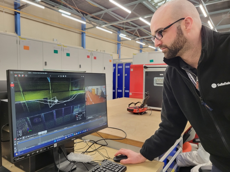 Engineer looking at screen display of the mapping images captured by the Flyability Elios 3 drone