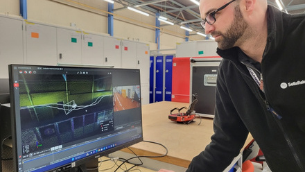 Engineer looking at screen display of the mapping images captured by the Flyability Elios 3 drone