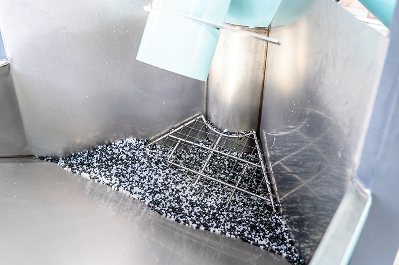 Stock image of an industrial plastics recycling plant machine containing pellets