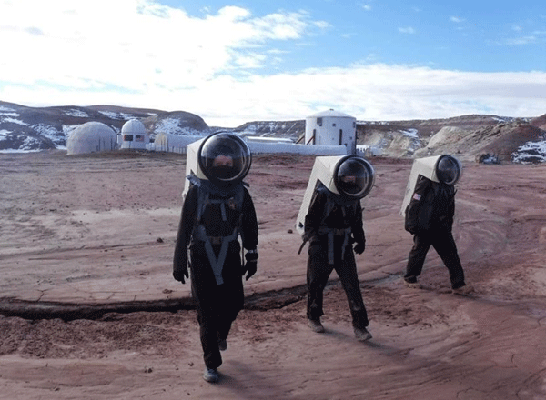 three people walking in the Mars Desert Research Station