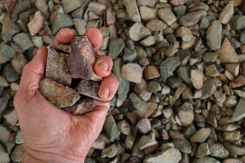 Stock image of rare-earth mineral ores being held in someone's hand