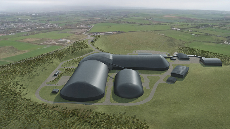 Digital image of a futuristic building complex made up of smooth, black, capsule-like buildings and domes, surrounded by green fields