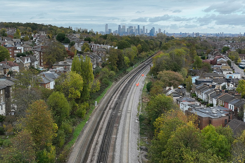 Stretch of railway from above with city in the background