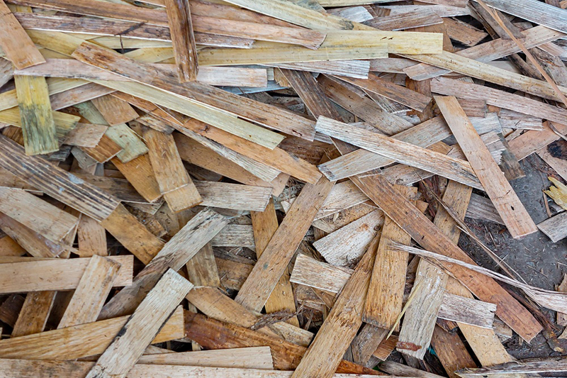 Industrial brown wood waste and scraps from plywood production piled in a heap