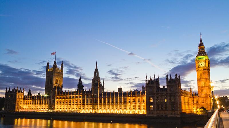 The UK Houses of Parliamnt with the river in the foreground, shot at night