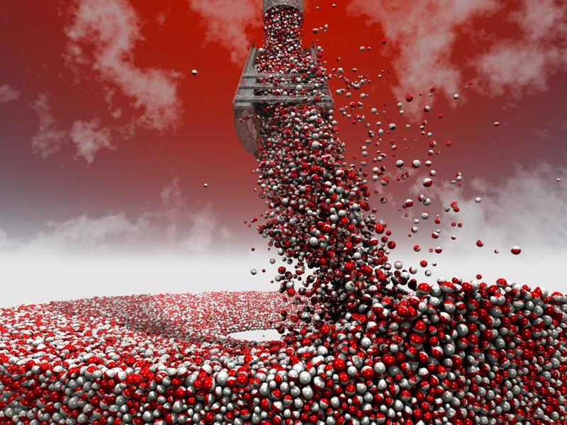 Pipe at the top of the image delivers silver and red balls through a grided chute below, the balls spill out onto a flat surface