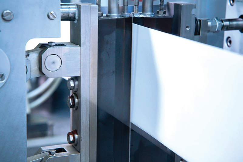 A paper web for packaging being sealed by a heat contact process in a specialised machine