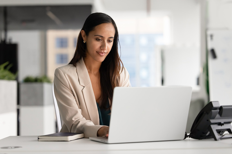 Female business professional working on a computer