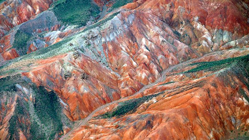 Mountain range with mineralisation signs, reddish and green colours visible