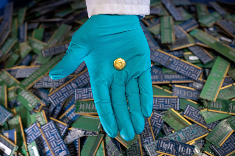 A hand holding gold recovered from electronic waste at The Royal Mint