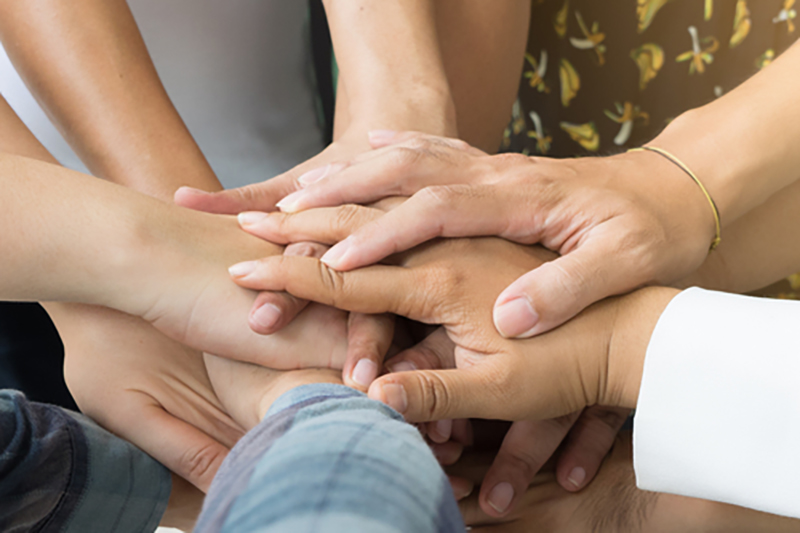 Team work concept. Business people joining hands