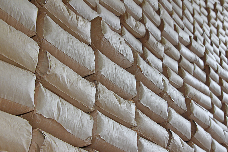 Stock image of sacks stacked up in a warehouse