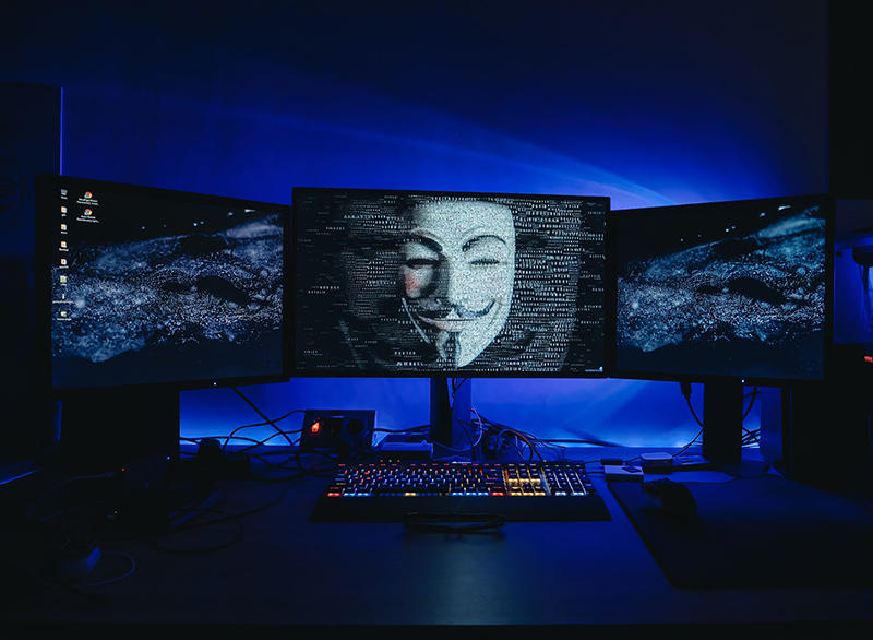 Computer with hacker symbol