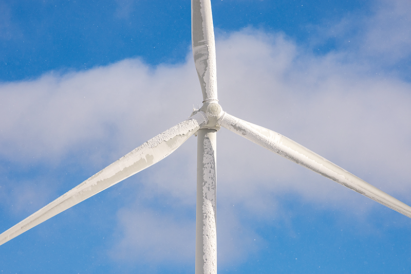 Stock image of an icy wind turbine up close