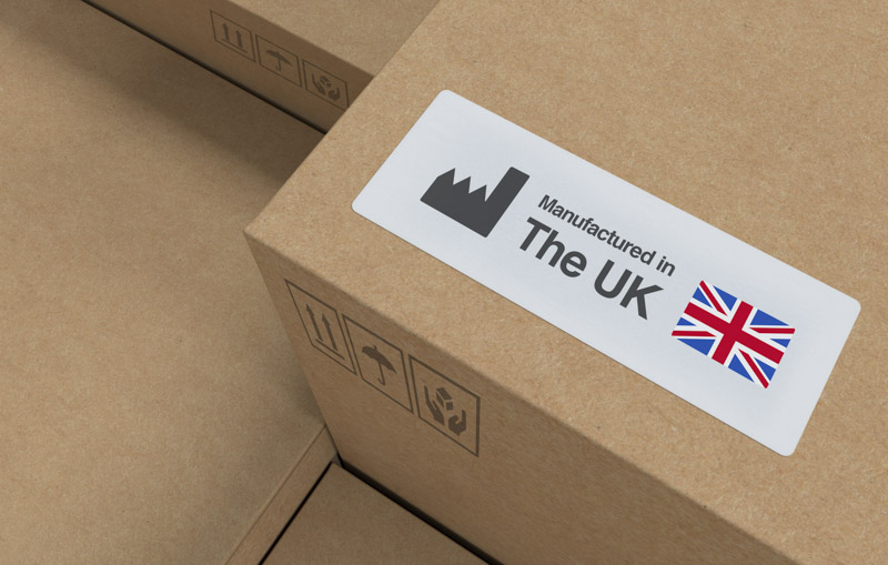 Cardboard box with manufactured in Britain written on it, with a British flag