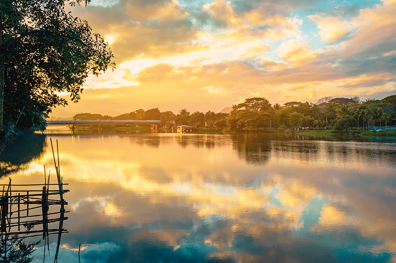 Stock image of Kok River, Chiang Rai Province, Thailand reflecting the sky at sunset