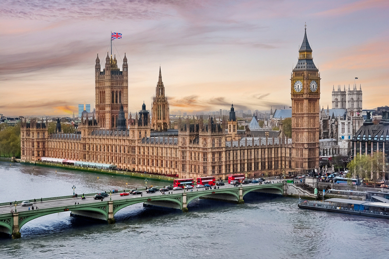 London cityscape with Houses of Parliament and Big Ben tower at sunset, UK