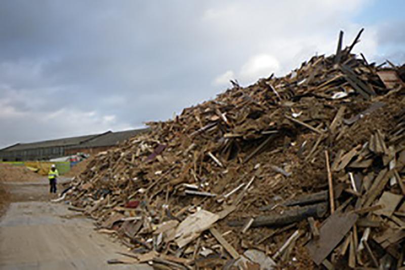 Waste wood exhibit with person in the background